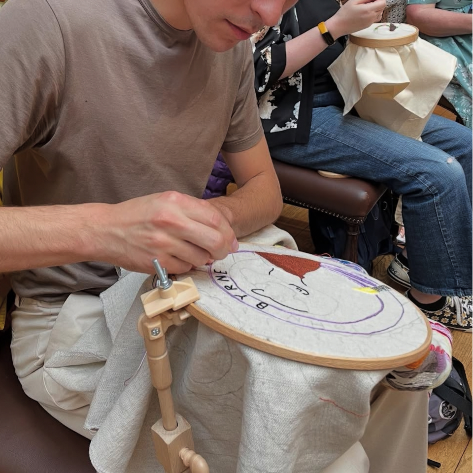 Stefan stitching on the Renfrewshire tapestry